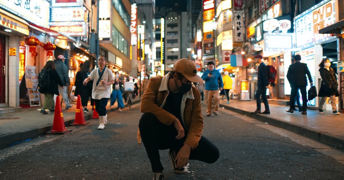 Eating while out on a public street in Japan - Photo of a Man in the Middle of the Road