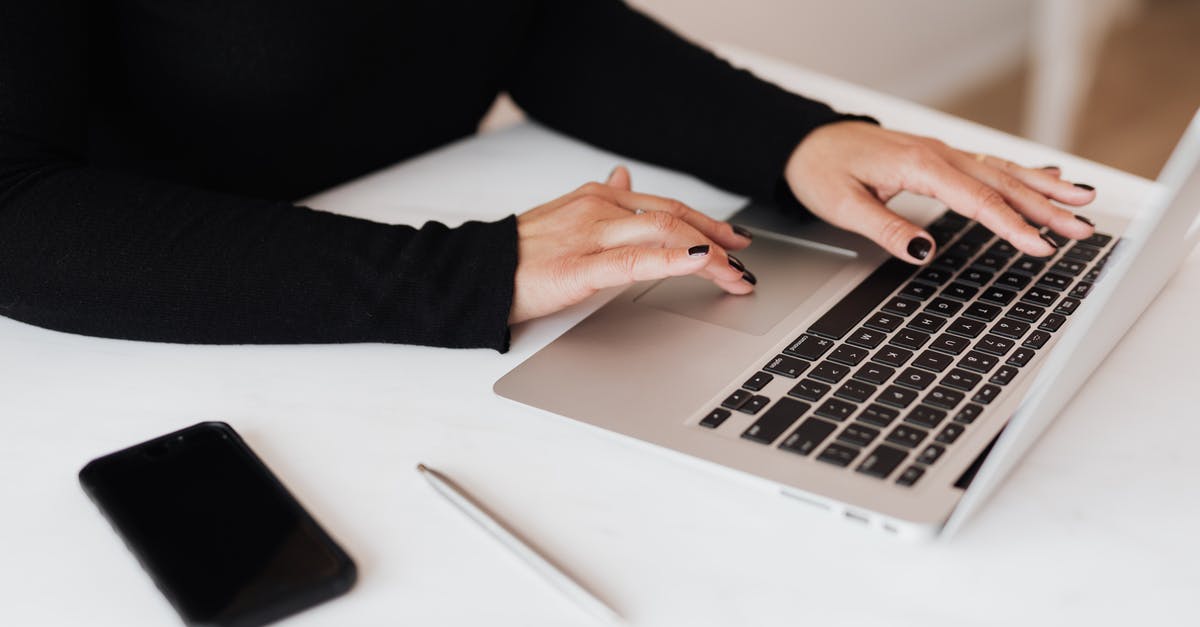 Economical mobile data for US and Canada - Crop faceless woman working on netbook in office