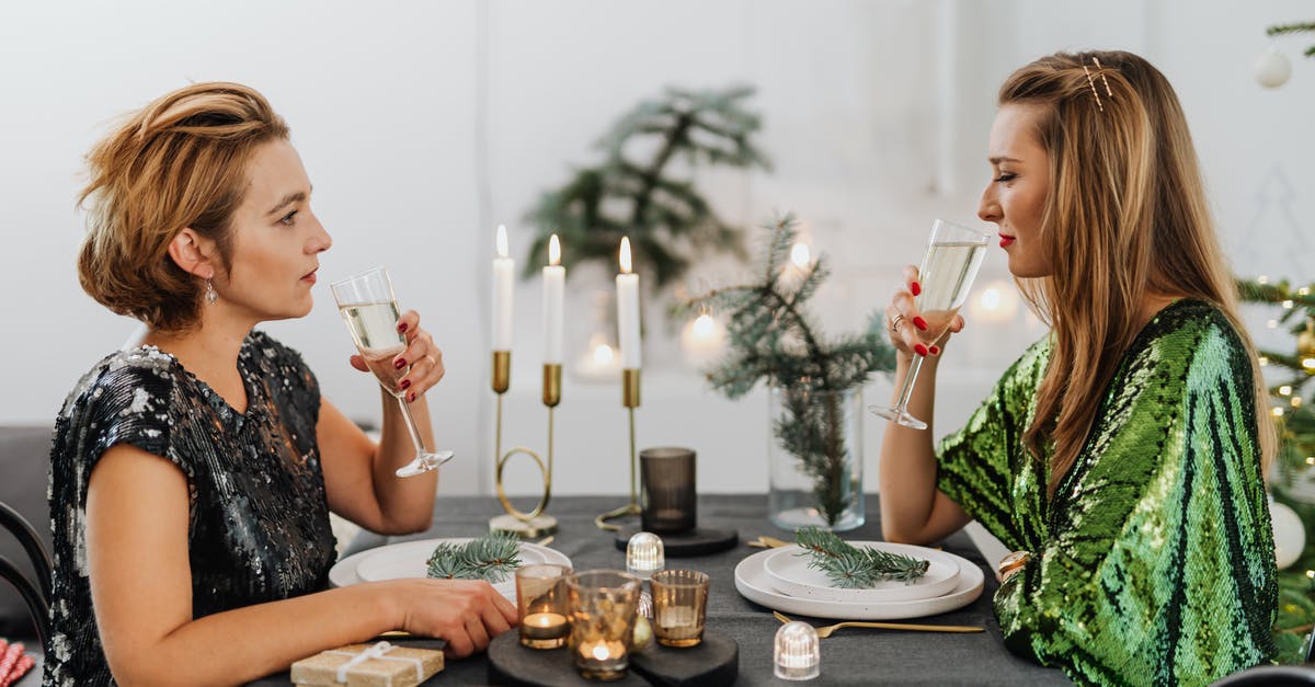 EEA family permit visa refusal: appeal or reapply? - Woman in Black and White Floral Dress Sitting on Chair in Front of Table With Plates