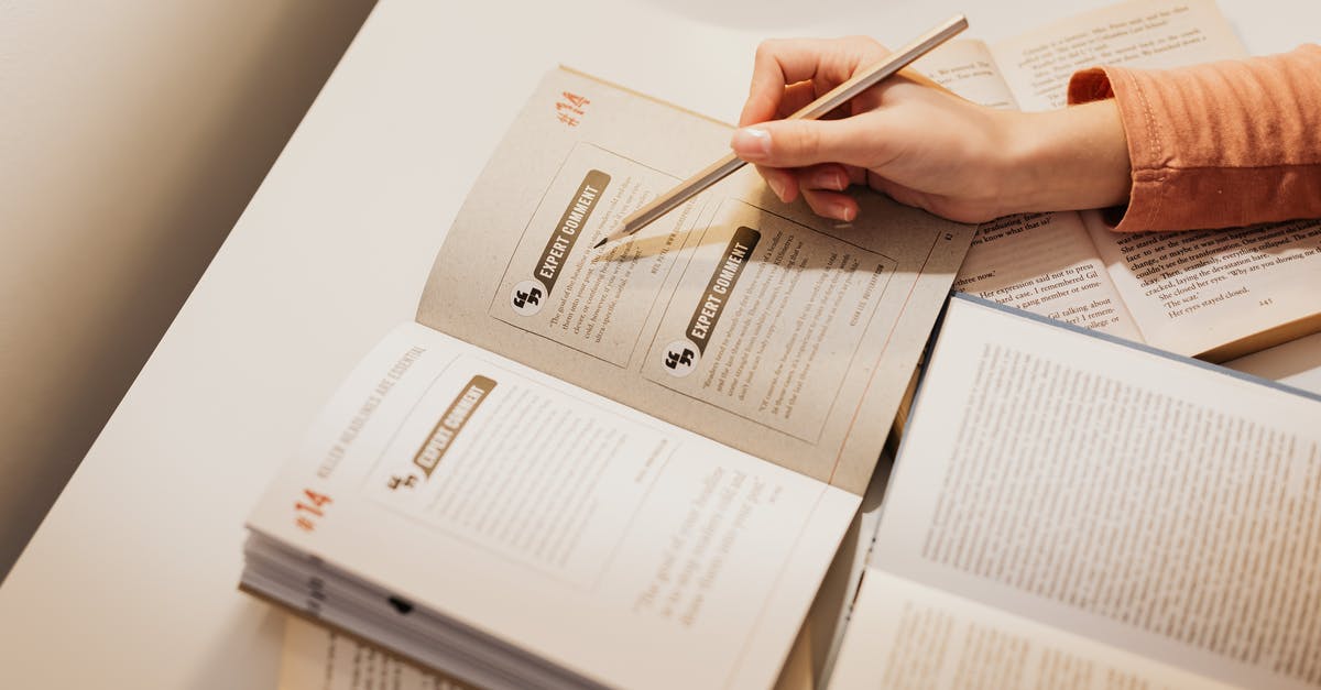 EHIC while interrupting studies? [closed] - Close-up of Open Books on a Desk and Woman Studying