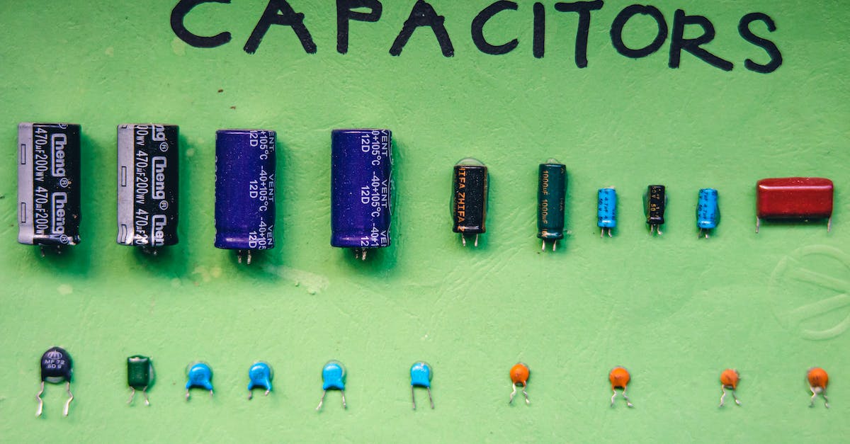 Electrical compatibility between different countries - Collection of capacitors on green surface