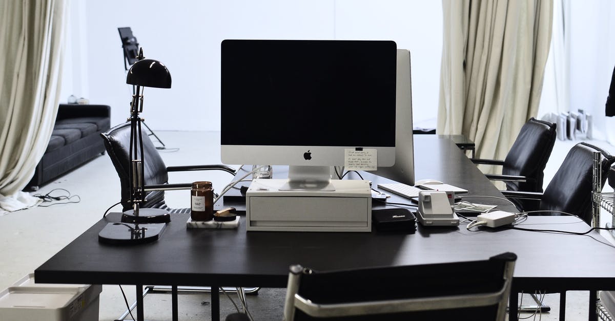 Electronic items limit to India [duplicate] - Interior of convenient workspace with contemporary computer placed on table with lamp in modern light office with couch against window