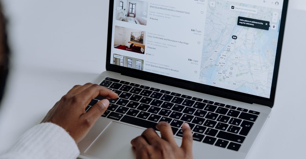 Electronic Map with Lodging pricing - Person Using Macbook Pro on White Table