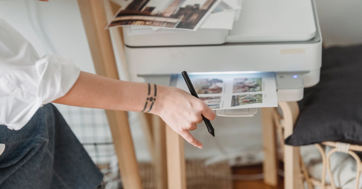 Electronic ticket with no printer - Woman printing photos on paper while forking at home