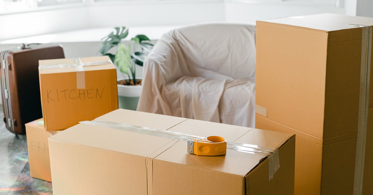 Electronics in sealed box as carry-on luggage: issues at security? - Empty apartment with packed carton boxes before moving
