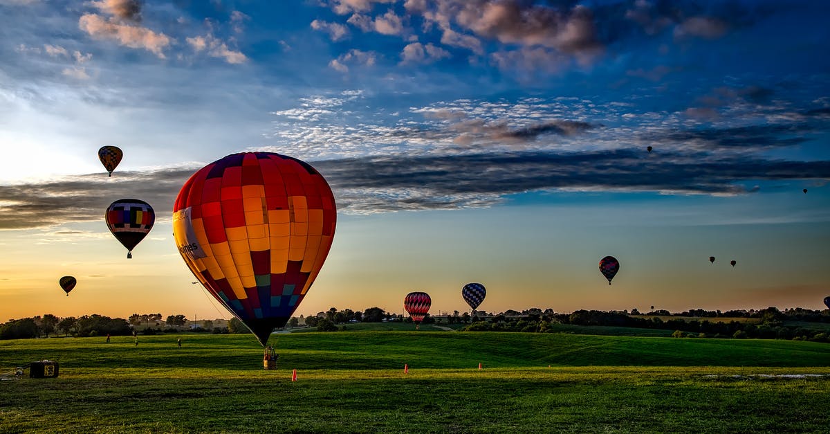 Eligibility for TWOV while flying Air Asia, transferring at KLIA2 - Assorted-color Hot Air Balloons on Grass Field during Golden Hour