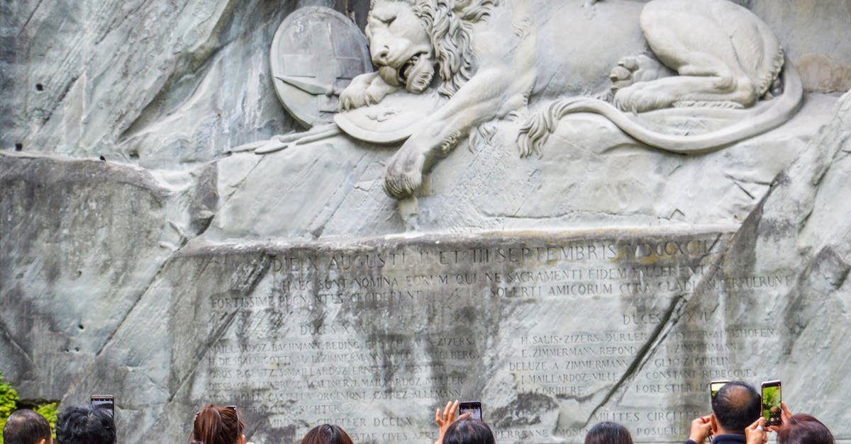 Elm, Switzerland - Suvorov monument and Glarus thrust - Tourists standing near Lion Monument in Switzerland