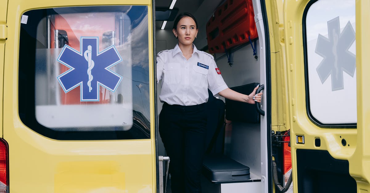 Emergency health care in England for a non-resident - A Paramedic Woman Standing Inside the Ambulance