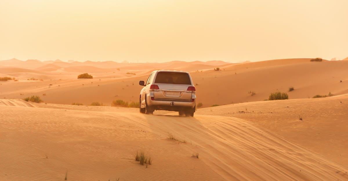 Emirates Dubai to Washington DC - PlayStation 4 on carry-on - White Suv on Desert