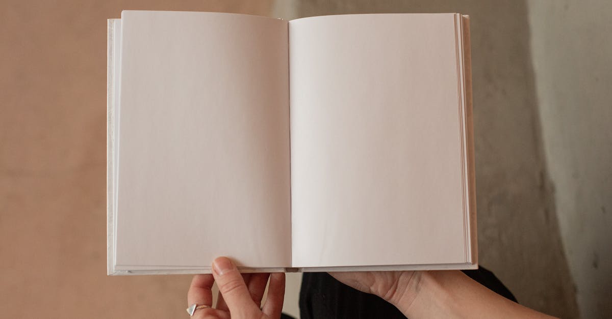 Empty page in passport between stamps - Woman holding book with blank pages