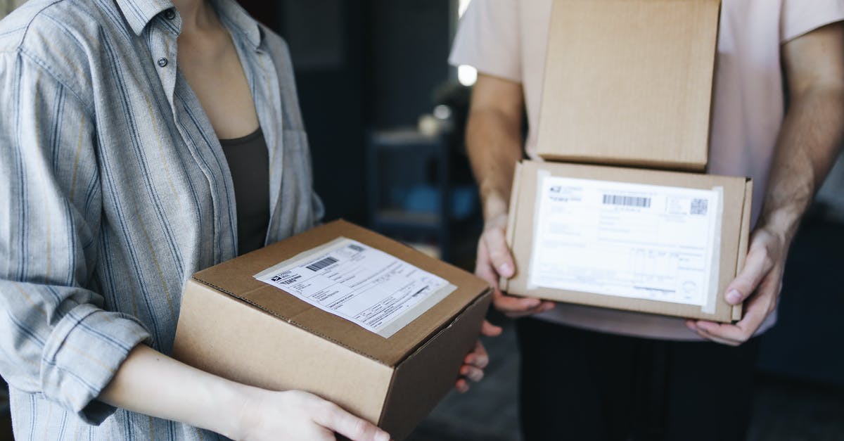 EMS packages opened at border? [closed] - Woman in Blue Denim Jacket Holding Brown Cardboard Box