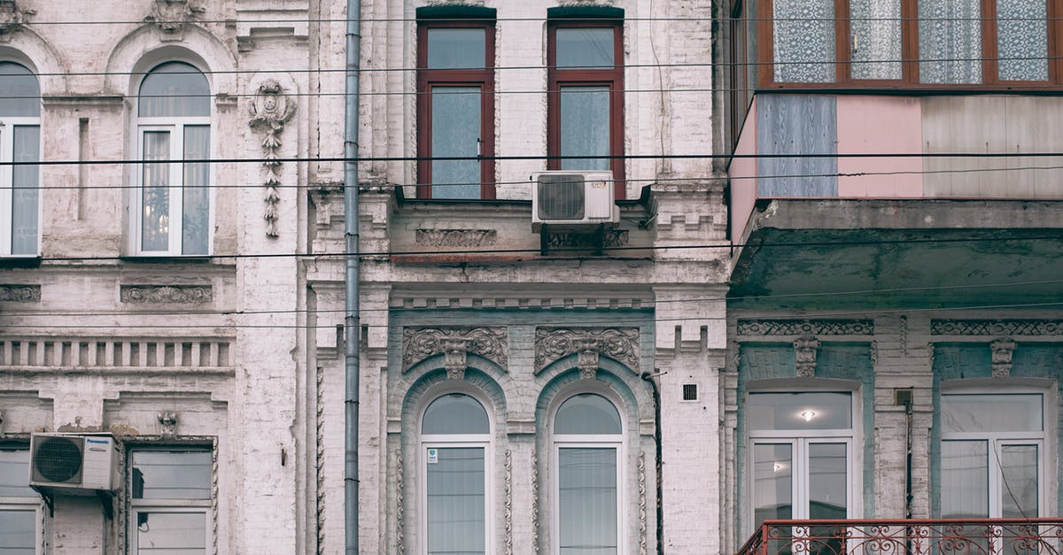 Entering and exiting Schengen area on different passports with different surnames - Facade of old stone building in classic style Entering and exiting Schengen area on different passports with different surnames - Facade of old stone building in classic style