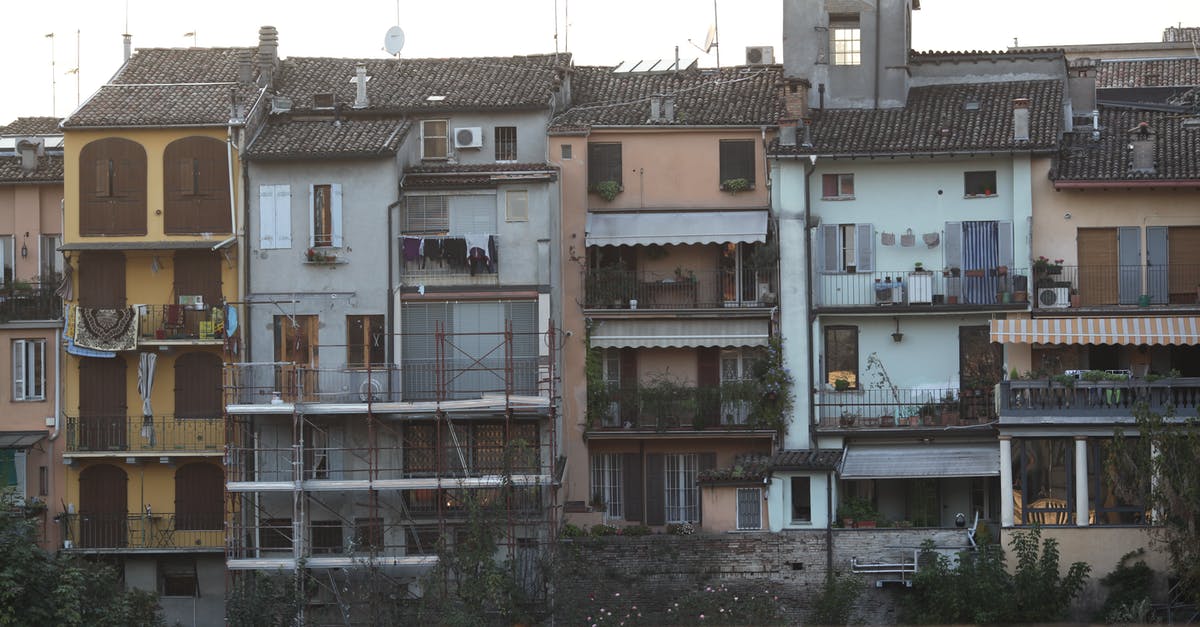 Entering and exiting Schengen area on different passports with different surnames - Exterior of attached old residential buildings Entering and exiting Schengen area on different passports with different surnames - Exterior of attached old residential buildings