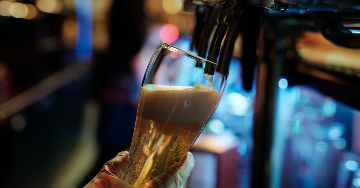 Entering Colombia with Alcohol - Person Holding Clear Drinking Glass With Brown Liquid