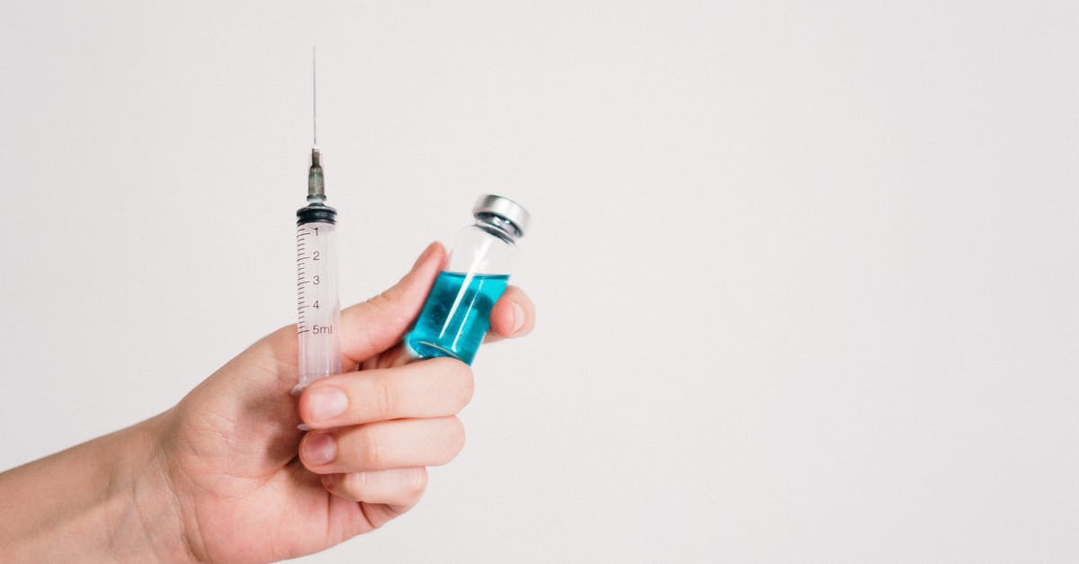 Entering France beyond vaccine certificate validity period - Person Holding Syringe and Vaccine Bottle