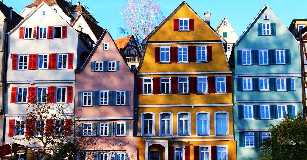 Entering Germany before granting of residence permit [closed] - White, Pink, Yellow, and Teal Painted Houses