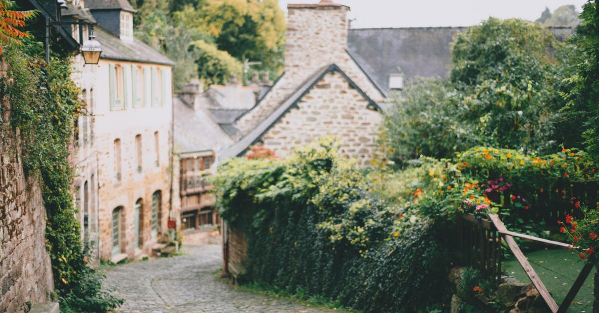 Entering Germany before granting of residence permit [closed] - Picturesque scenery of stone houses surrounded with lush trees