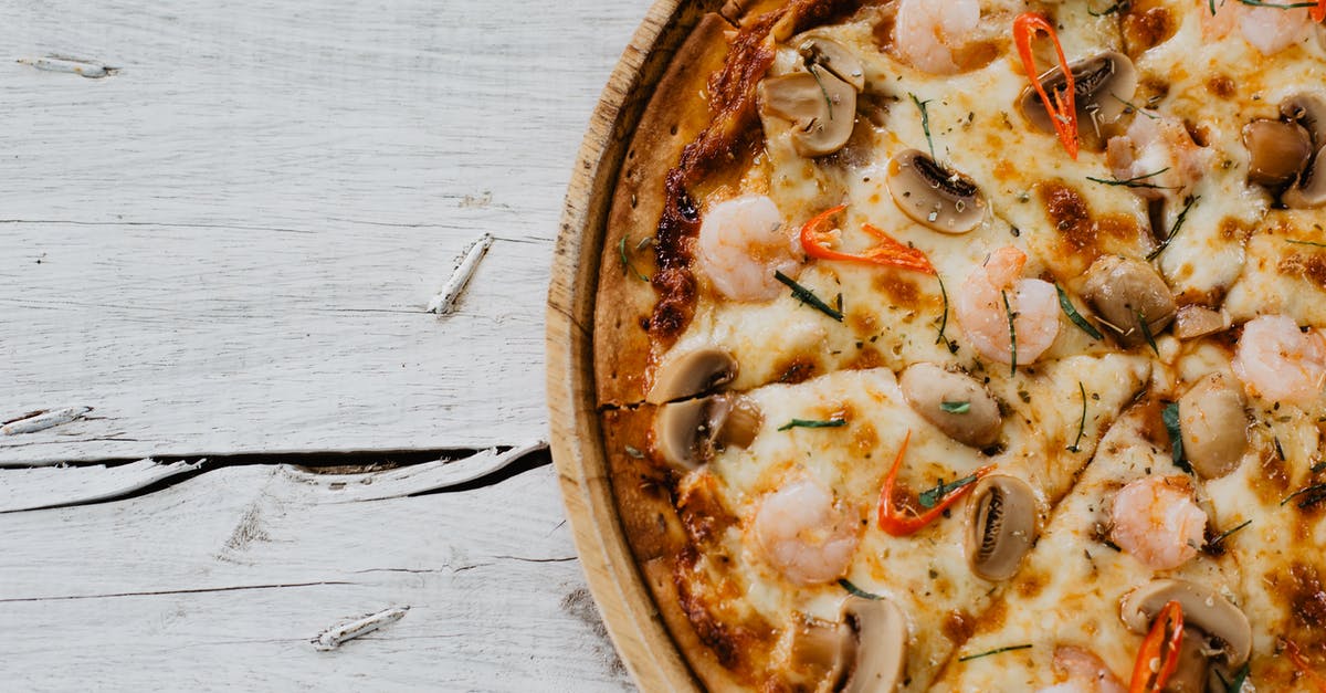 Entering Spain with a Schengen visa taken from Italian embassy [duplicate] - Appetizing pizza with shrimps and champignon on wooden table