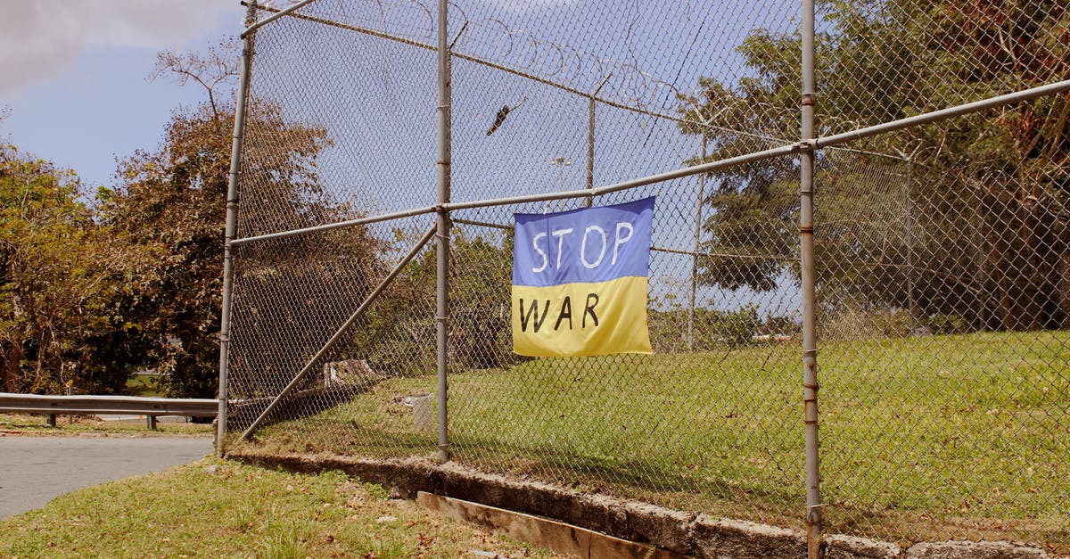 Entering Ukraine as a Ukrainian born, naturalised British citizen - A Banner on a Metal Fence