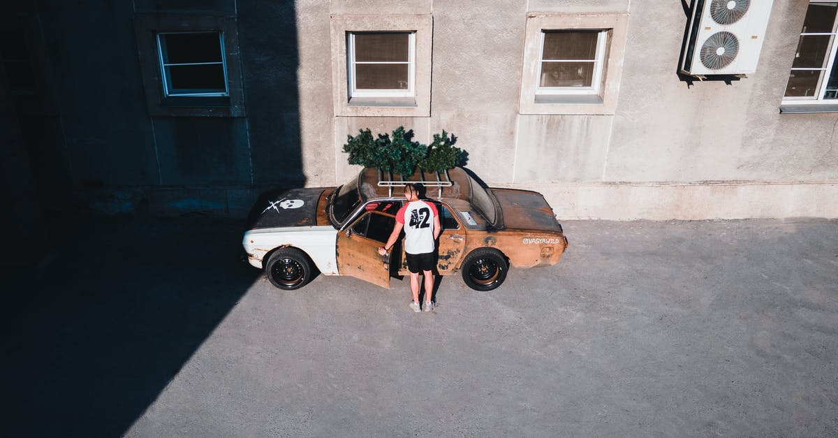 Entering Ukraine with someone else's car - Man Entering a Rusty Car