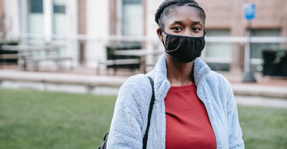 Entry into Canada for Candian citizens during COVID-19 period [duplicate] - Anonymous young African American female in face mask looking at camera in town during coronavirus pandemic