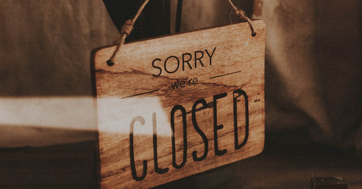 Entry into France [closed] - Through glass of wooden signboard with inscription Sorry We Are Closed hanging on doors of shop