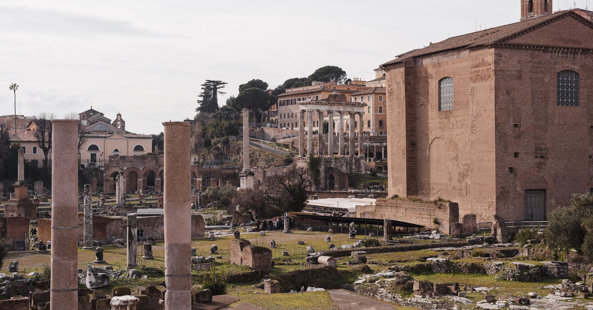 Entry permit to italy with polish national visa [duplicate] - Roman Forum with old building facades and columns in city