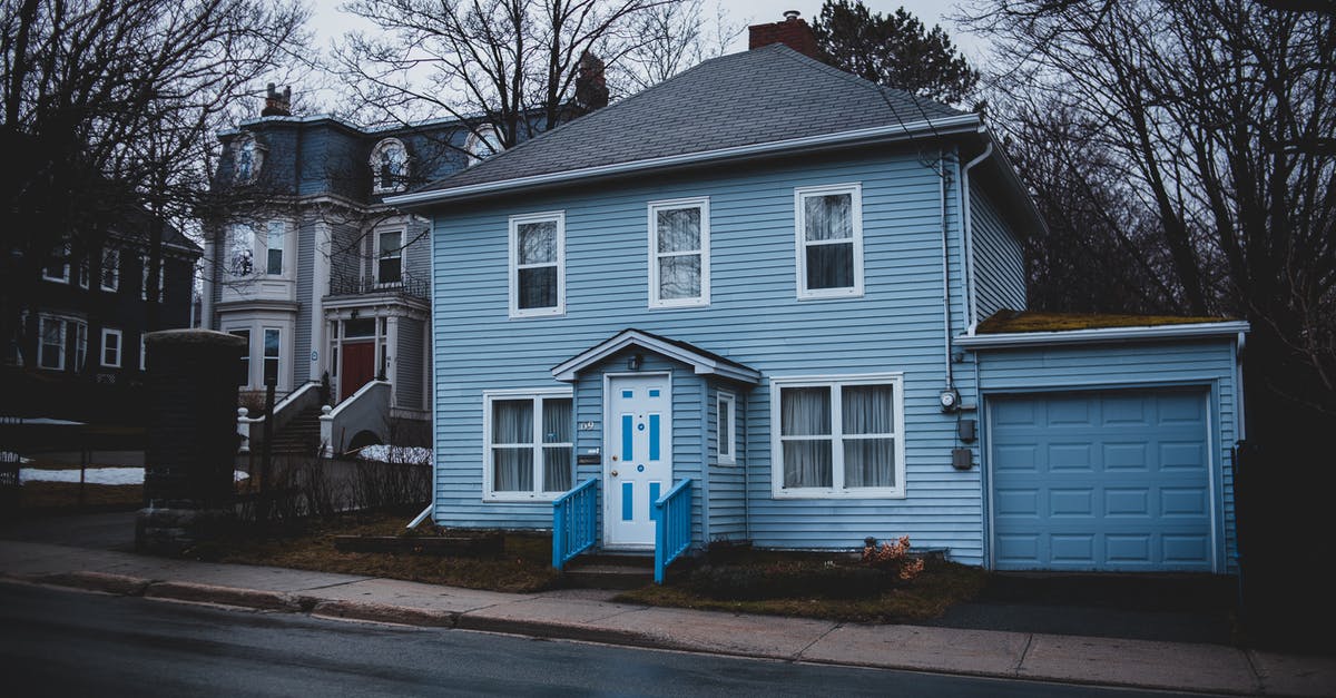 Entry restrictions for Schengen visa - Old residential house trimmed with light blue siding and garage