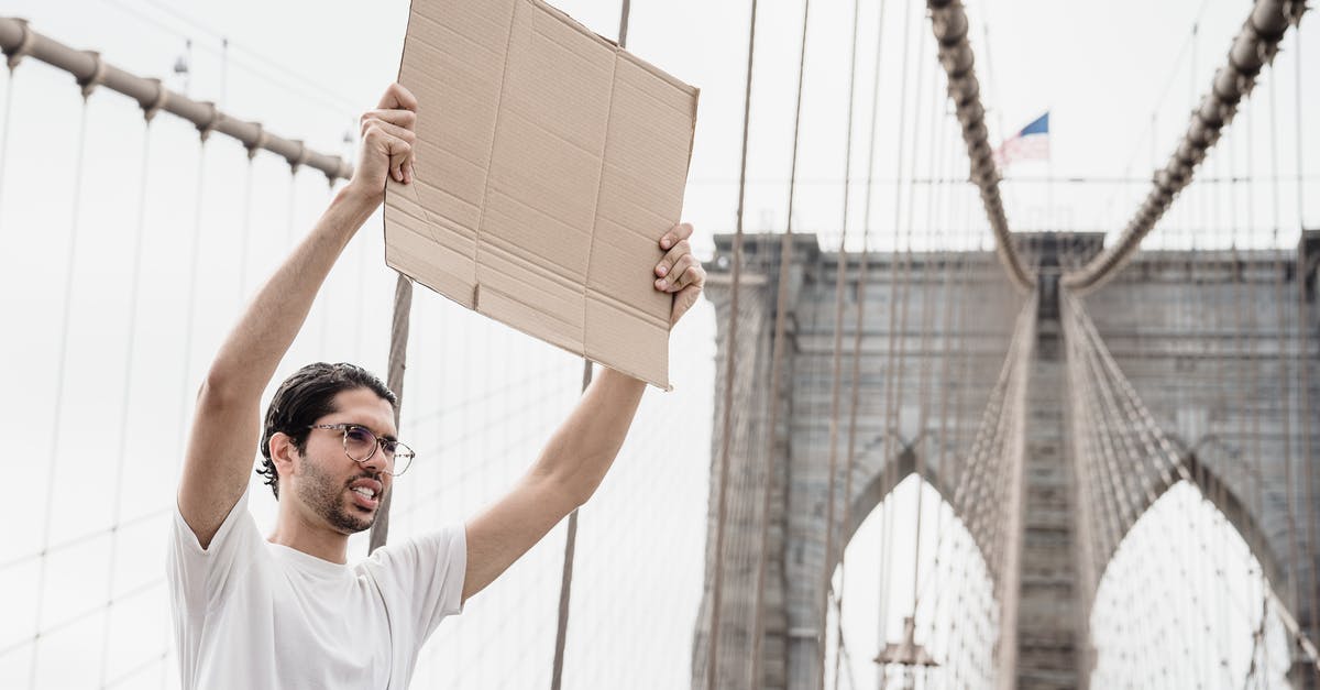 Entry to USA after previous denial - A Man with a Blank Placard Raised above His Head