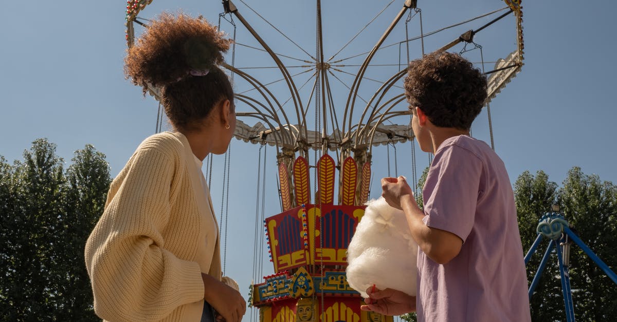 ESTA 90 day start date - Teenage couple on date in amusement park looking at big carousel