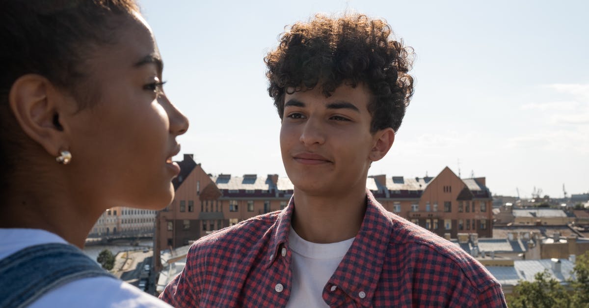 ESTA 90 day start date - Teenagers standing on rooftop talking and looking at each other