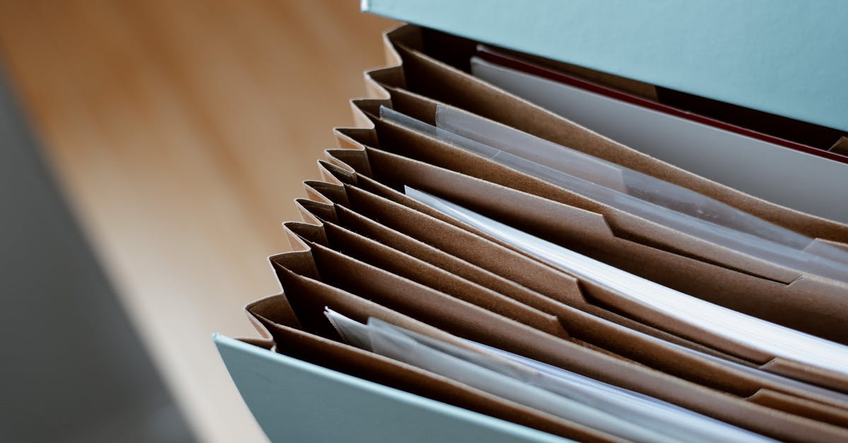 ESTA application paperwork - High angle of opened briefcase for documents with papers accosted in order placed on wooden table