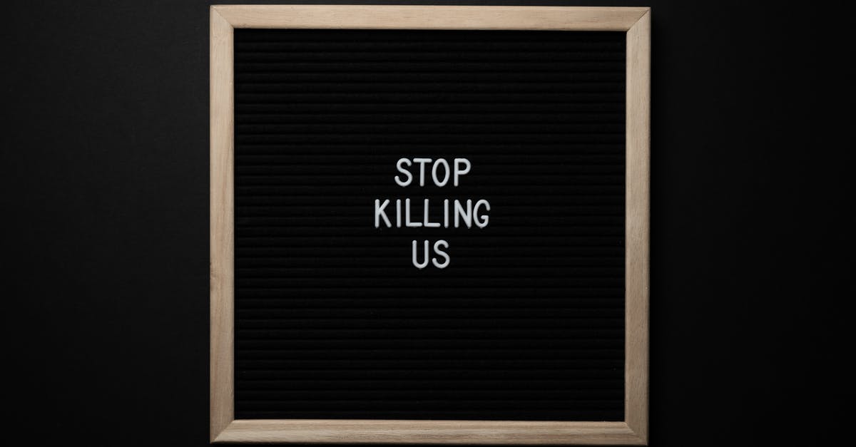 ESTA approved, but could there be problems entering the USA? - Top view of slogan Stop Killing Us on surface of square blackboard on black background