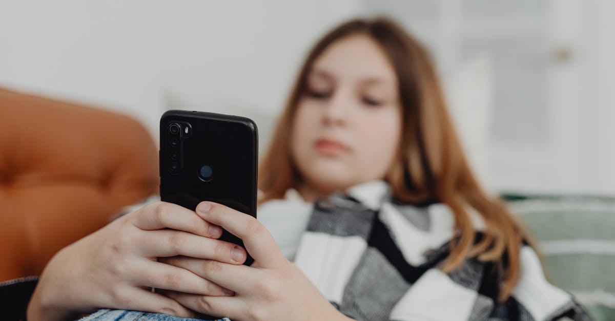 Etihad Airways connection in Brisbane to Auckland - Girl Lying on Sofa and Using Smartphone