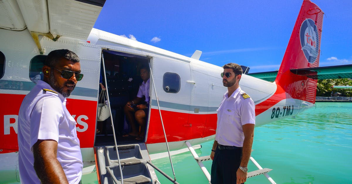 Eu 261 query on multi flight ticket during BA pilots strike - Man Standing Beside of White and Red Airplane