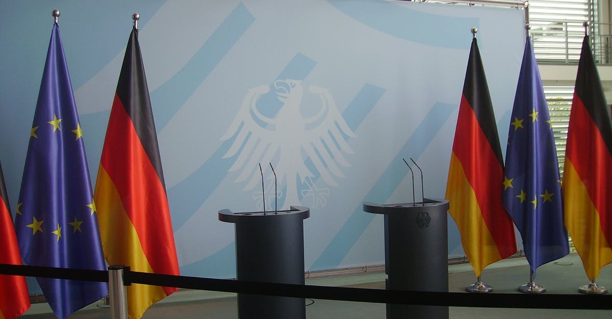 EU citizen and non-EU spouse entering the EU (Schengen area) - Six Assorted-color Flags Hanging on Gray Stainless Steel Poles