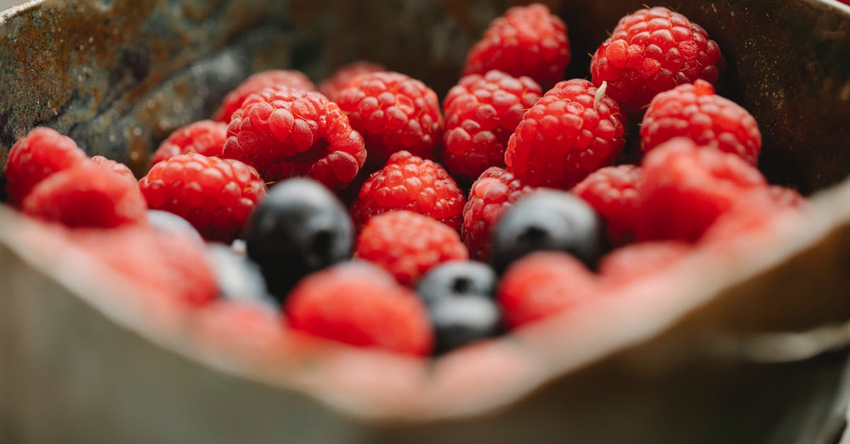 EU Healthcare for an EU citizen living in the UK - Appetizing ripe raspberries and blueberries in bowl