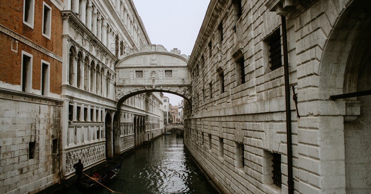 EU resident and 90-day rule in Italy - Boat on River Between Buildings