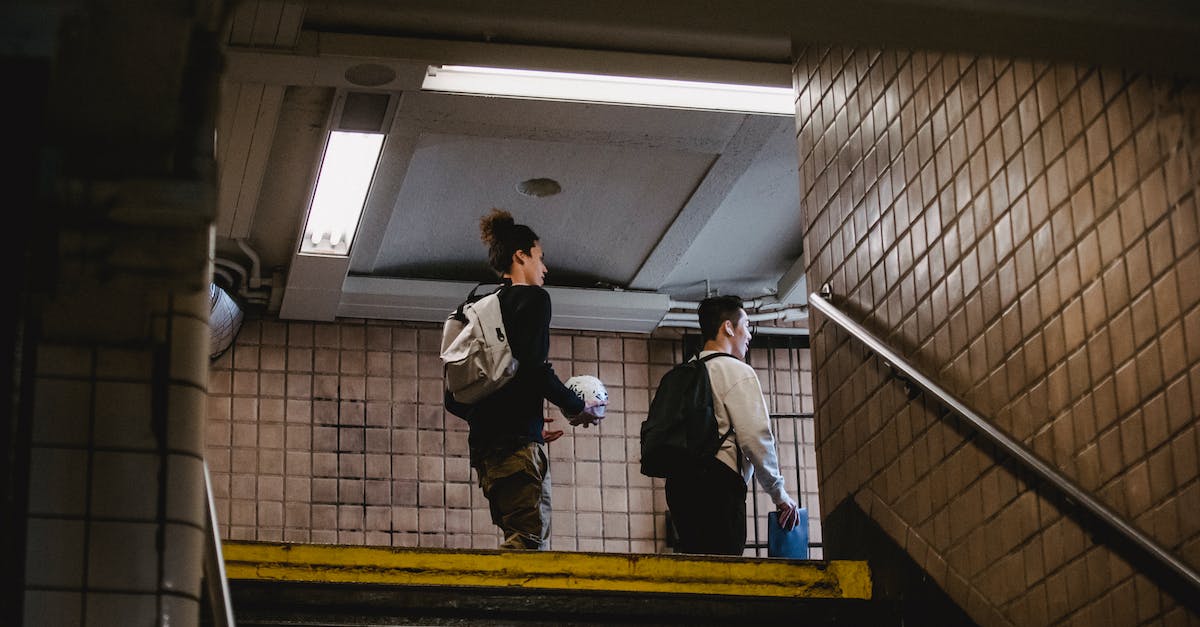 Eurail Pass from Lyon to Milan - Young men walking on metro staircase