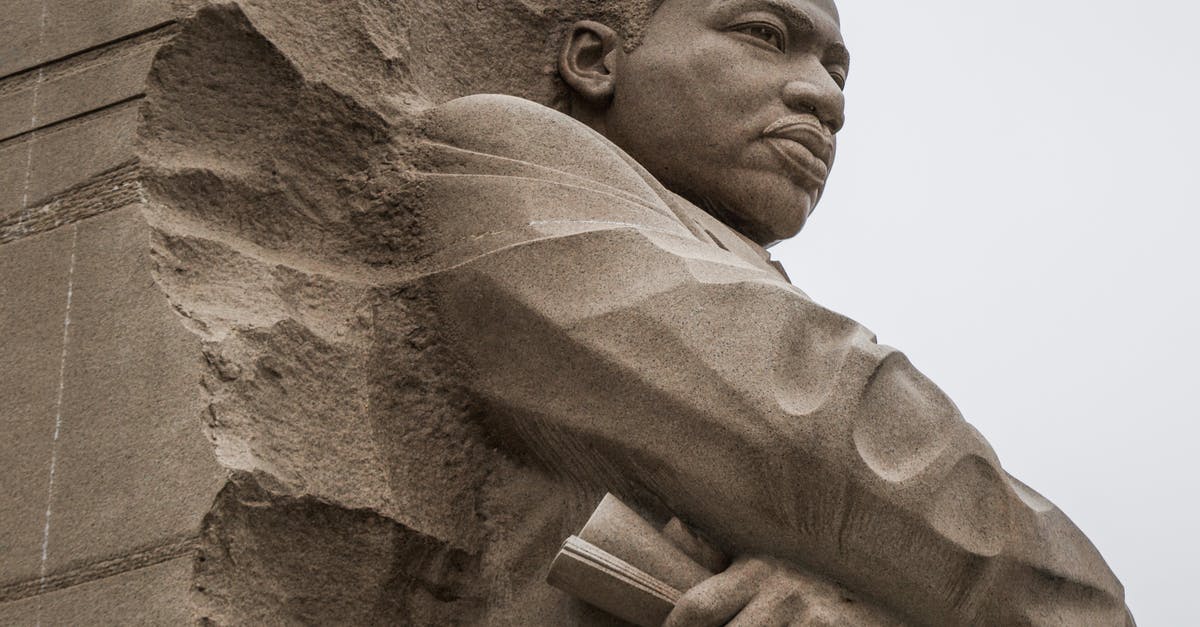 Euro Trip through UK from USA - Granite statue of civil rights movement leader against overcast sky