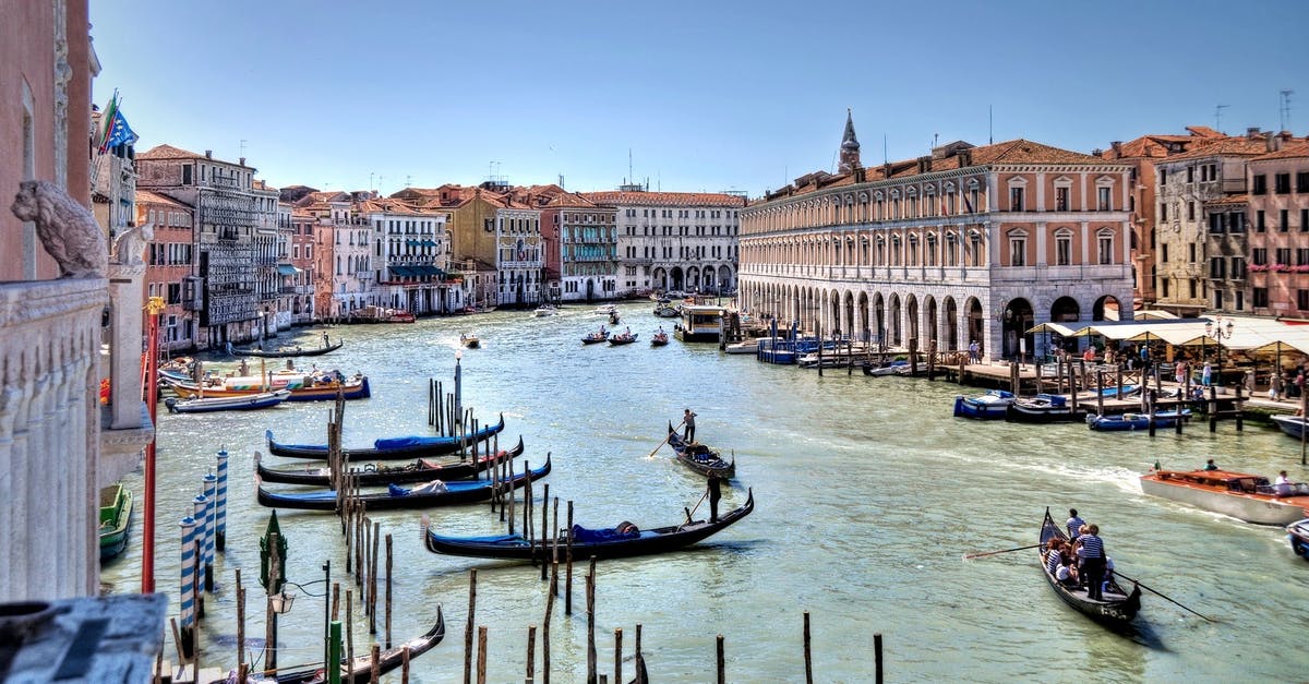 Europe working holiday for an Australian - Body of Water With People Rowring on Boat Beside Tall Building