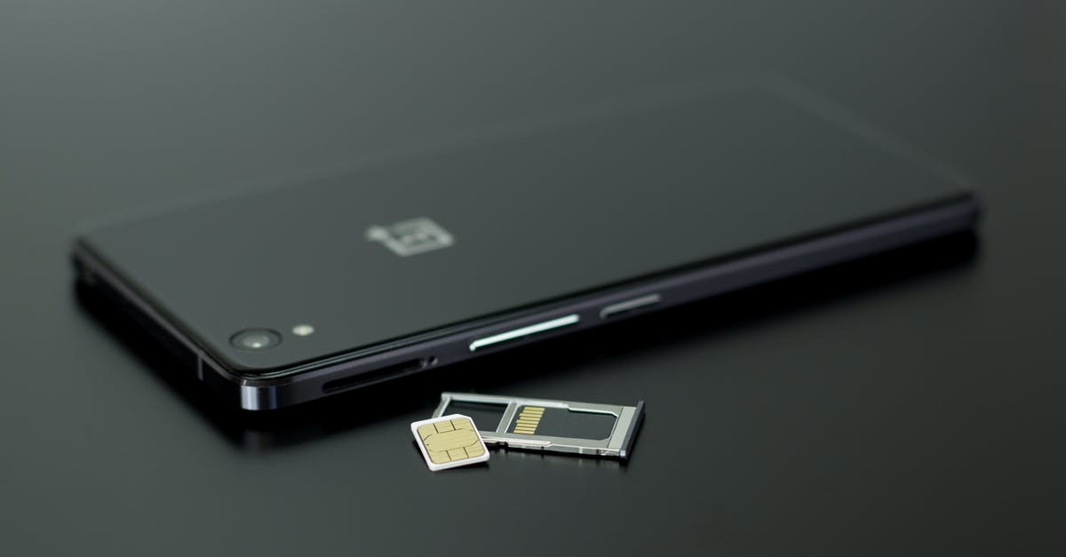 European SIM card in US mobile phone - Black Smartphone on Black Table Top