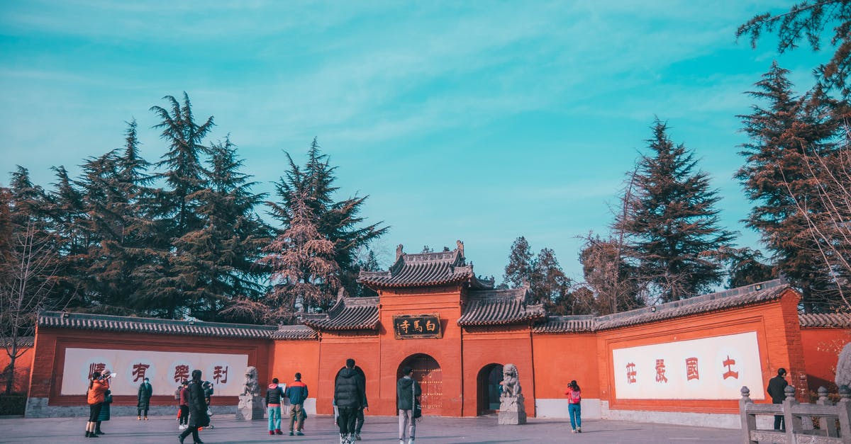 Examples of higher prices charged to tourists vs. locals [closed] - People Walking on Street Near Red Building