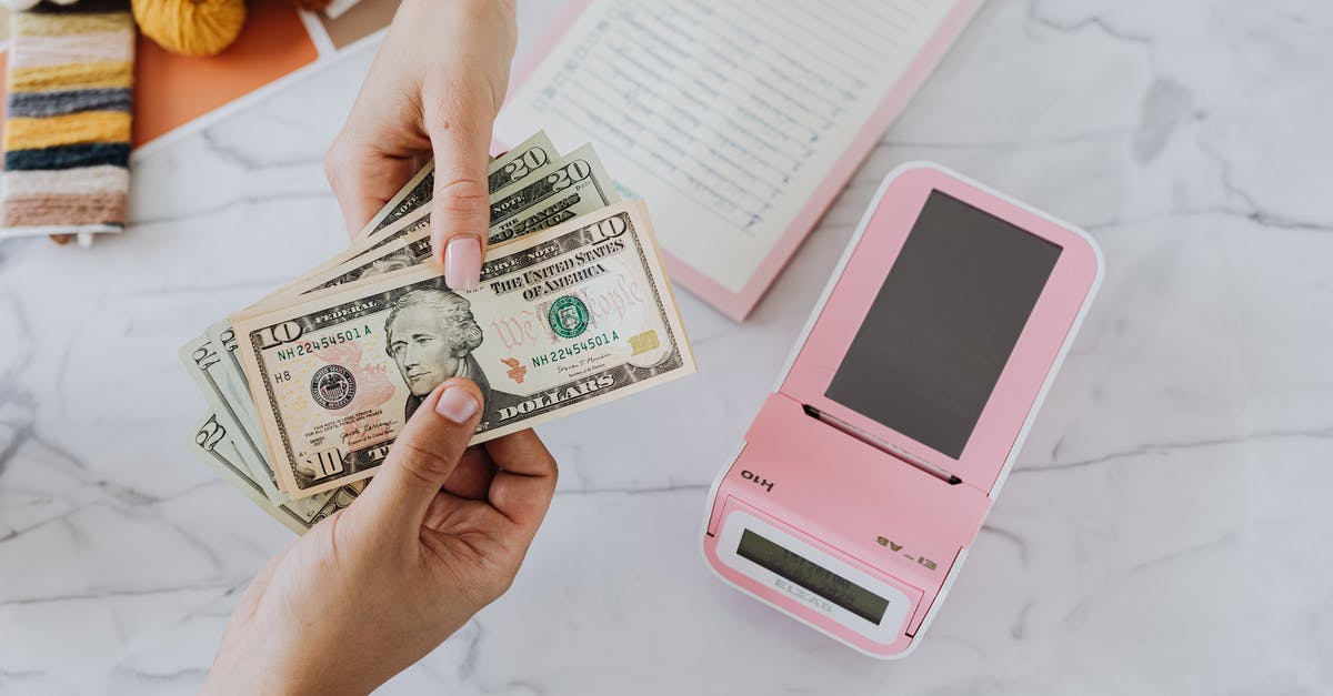 Exchanging Dollars for Yuan - Hands Holding Dollars