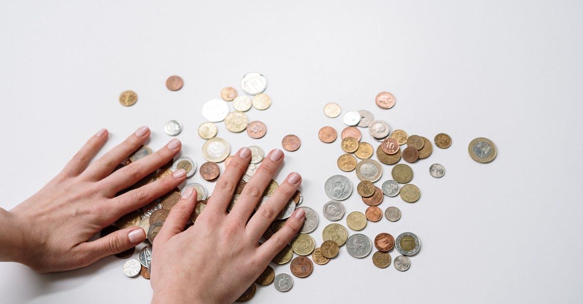 Exchanging Dollars for Yuan - Person Holding Silver Round Coins