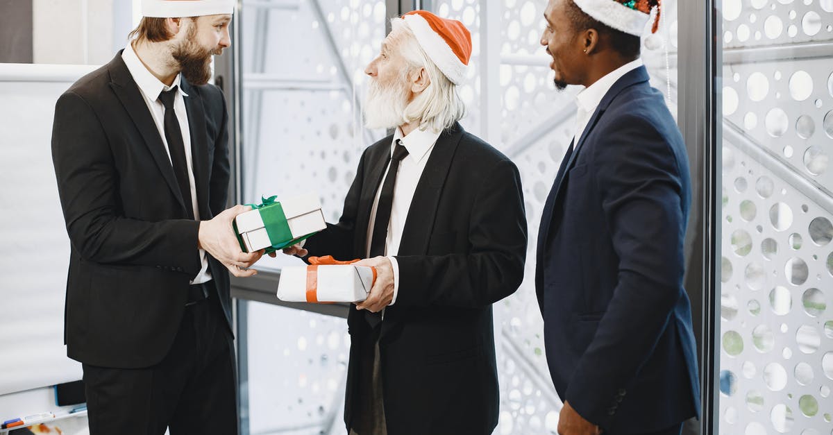 Exchanging South Korean Won for Turkish Lira [duplicate] - Businessmen in Santa Hats Exchanging Gifts