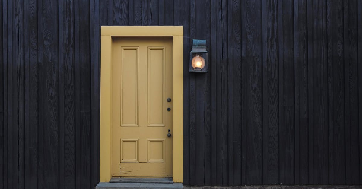 Exit Tax When Exiting Panama by Foot? - Closed Door and Lighted Light Sconce