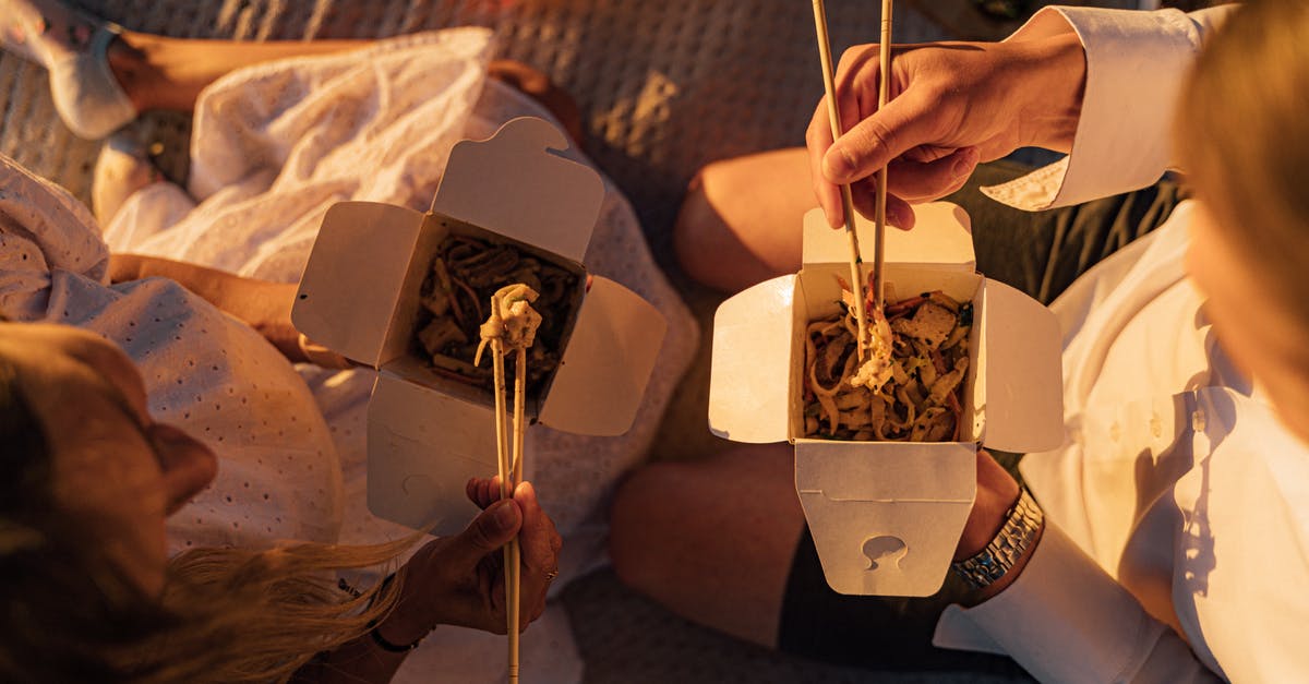 Expected tax (GST) when eating out in India? - Person Holding Brown Wooden Chopsticks While Eating Noodles