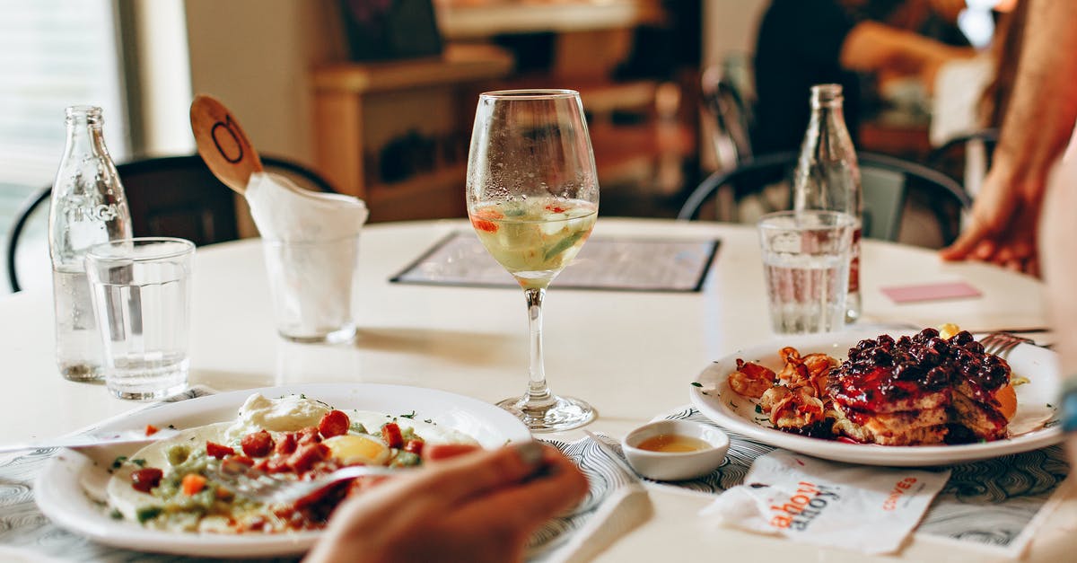 Expected tax (GST) when eating out in India? - Wine in Clear Glass Near Food on Plate on Table