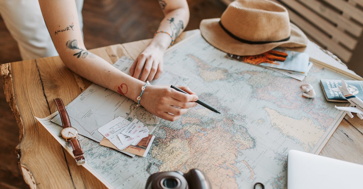 Expired destination (U.S.) passport; unexpired dwelling (Israel) passport - A Woman Checking a World Map